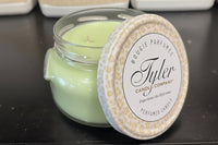 Tyler Candle Company candle with a decorative lid on a dark surface