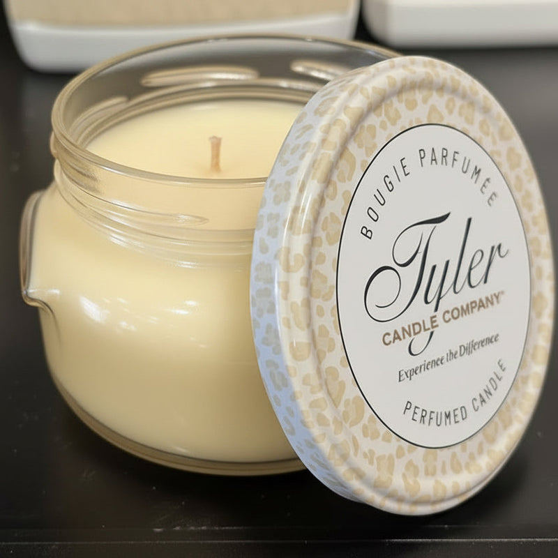 Tyler Candle Company candle with a decorative lid on a dark surface