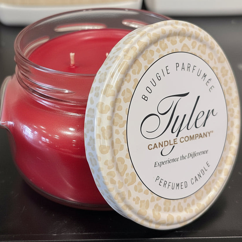 Tyler Candle Company candle with a decorative lid on a dark surface