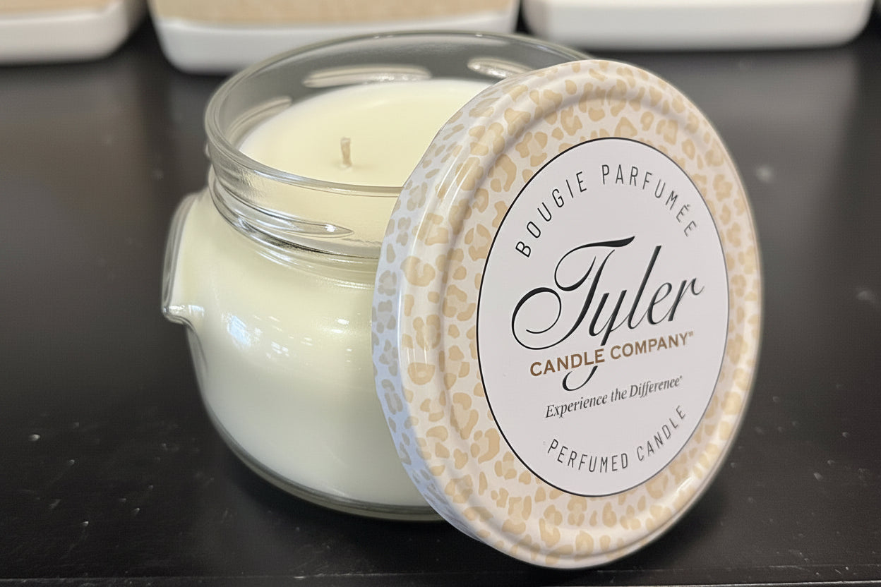 Tyler Candle Company candle with a decorative lid on a dark surface