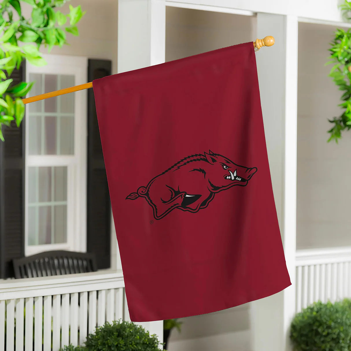 Red flag with a black logo of a ram on a white railing.