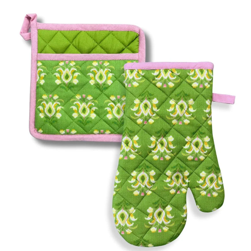 Green oven mitt and pot holder with pink floral patterns on a white background