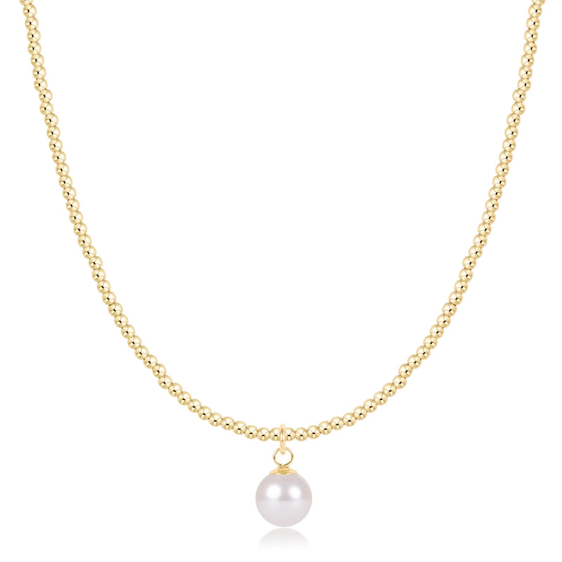A delicate gold chain necklace featuring a single white freshwater pearl pendant, displayed against a solid white background.

