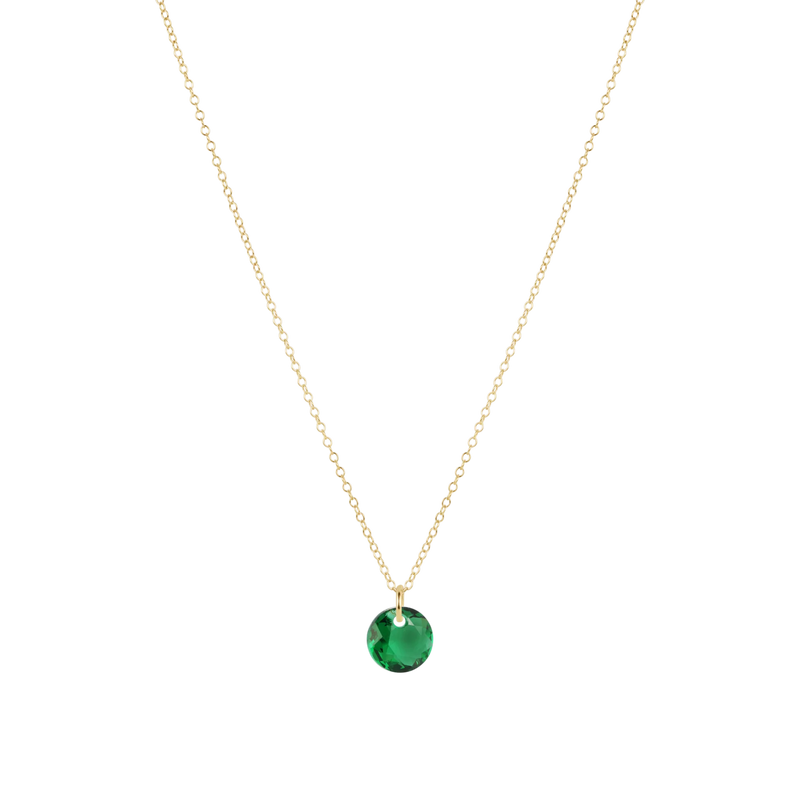 Gold necklace with a green gemstone pendant on a white background
