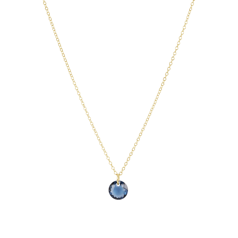 Gold necklace with a blue pendant on a white background