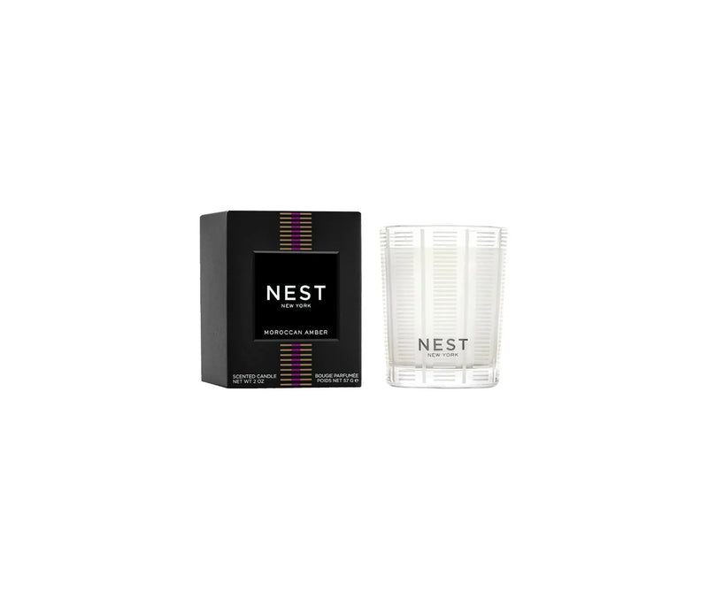 White candle with black box with a white background