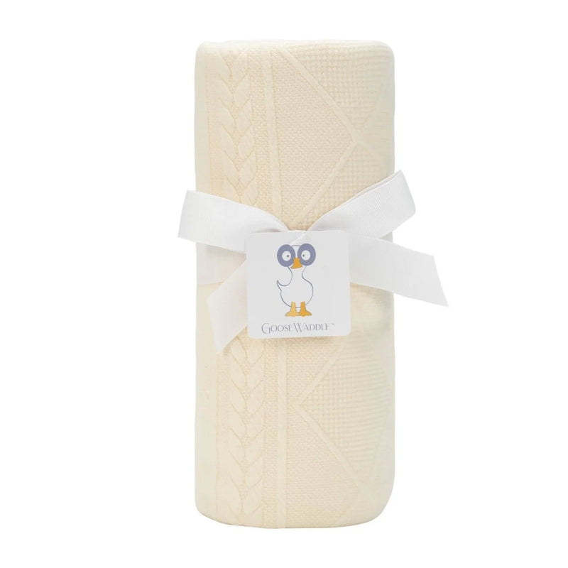 Folded beige fabric with a white ribbon and label on a white background