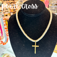 Pearl necklace with a gold cross pendant on a black velvet stand, with 'pearl cross' text above.