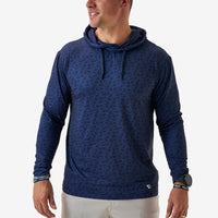 Man wearing a blue patterned hoodie on a white background