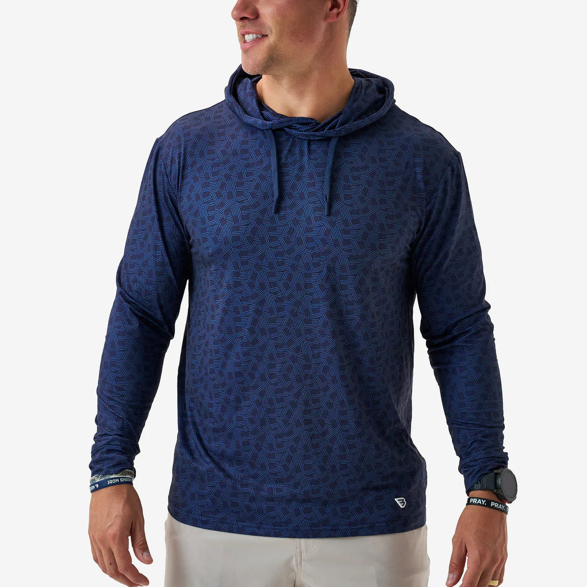 Man wearing a blue patterned hoodie on a white background