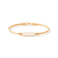 Gold bracelet with silver beads on white background