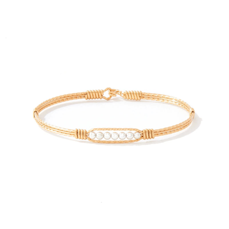 Gold bracelet with silver beads on white background