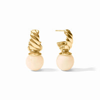 A pair of gold huggie hoop earrings with a twisted spiral top and a smooth, round pale pink bead drop, shown on a clean white background.