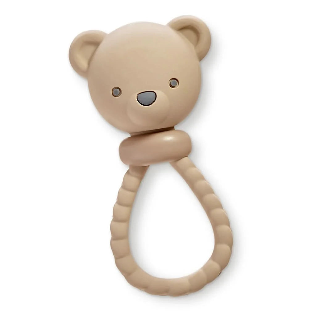 A beige silicone baby teether shaped like a teddy bear head with a textured ring handle, shown on a plain white background.
