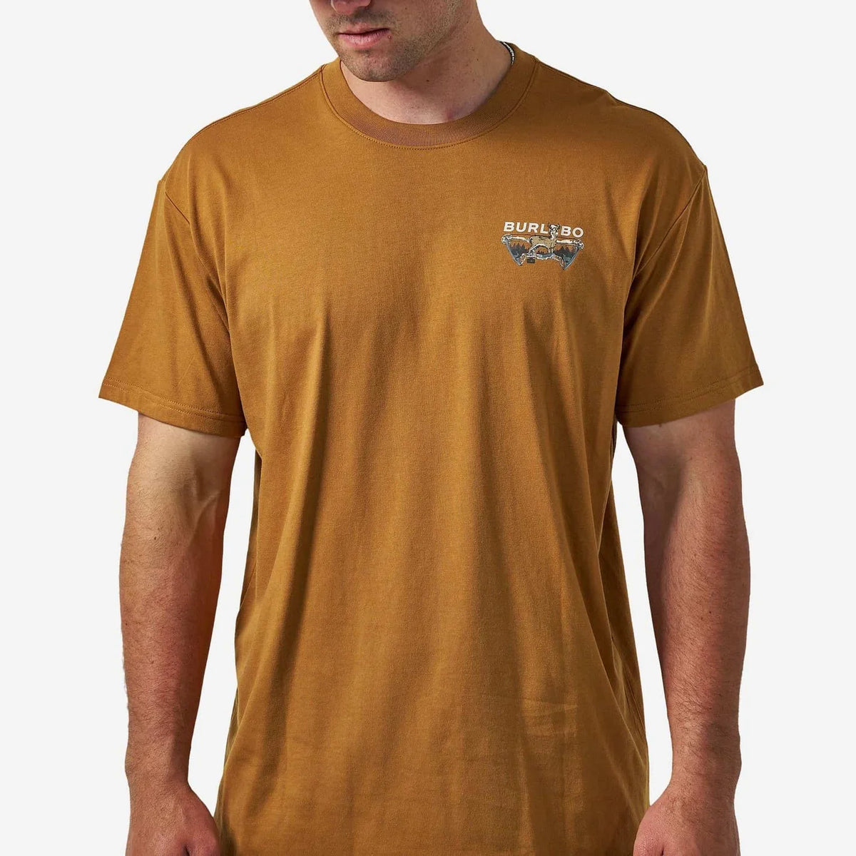 A man wearing a short-sleeve crewneck t-shirt in a washed mustard brown color, featuring a small 'BURL' graphic on the left chest, against a light gray background.