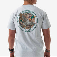 Gray t-shirt with a duck graphic and text on the back, worn by a person.