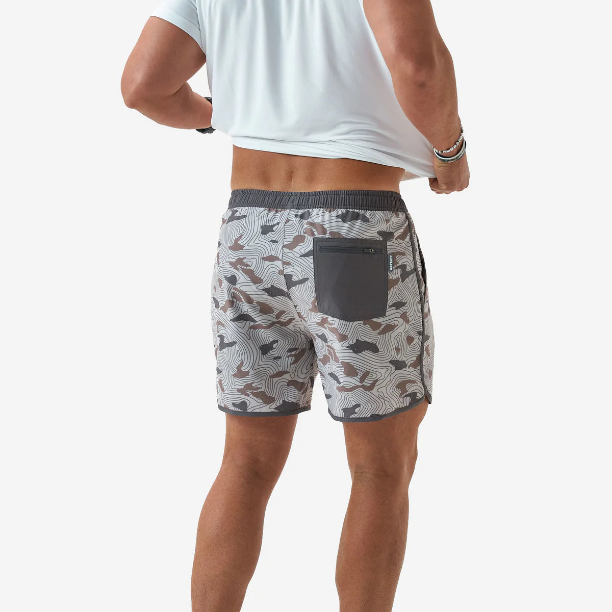Person wearing patterned shorts with a white background