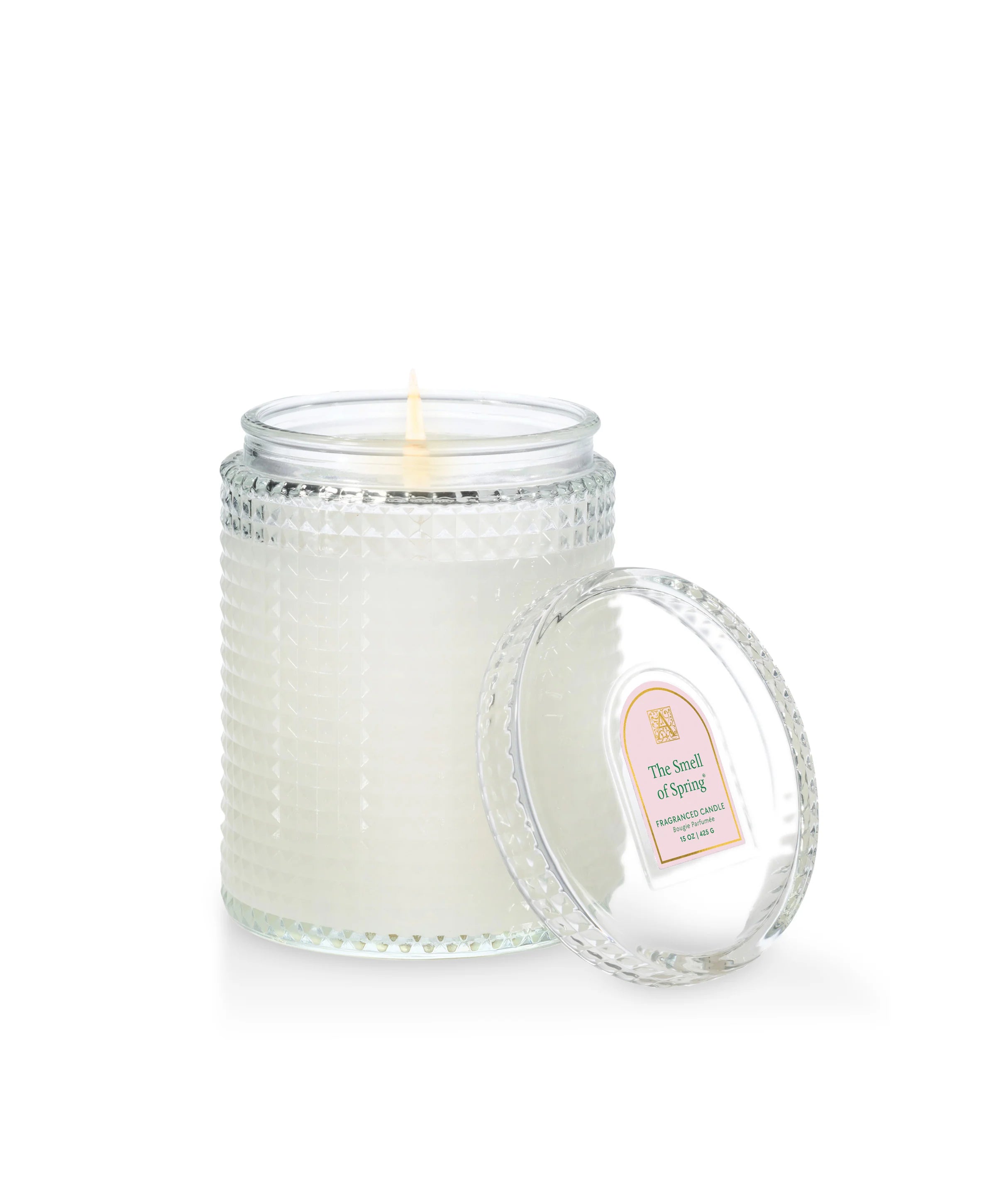 Glass candle with a beaded design and a label on a white background