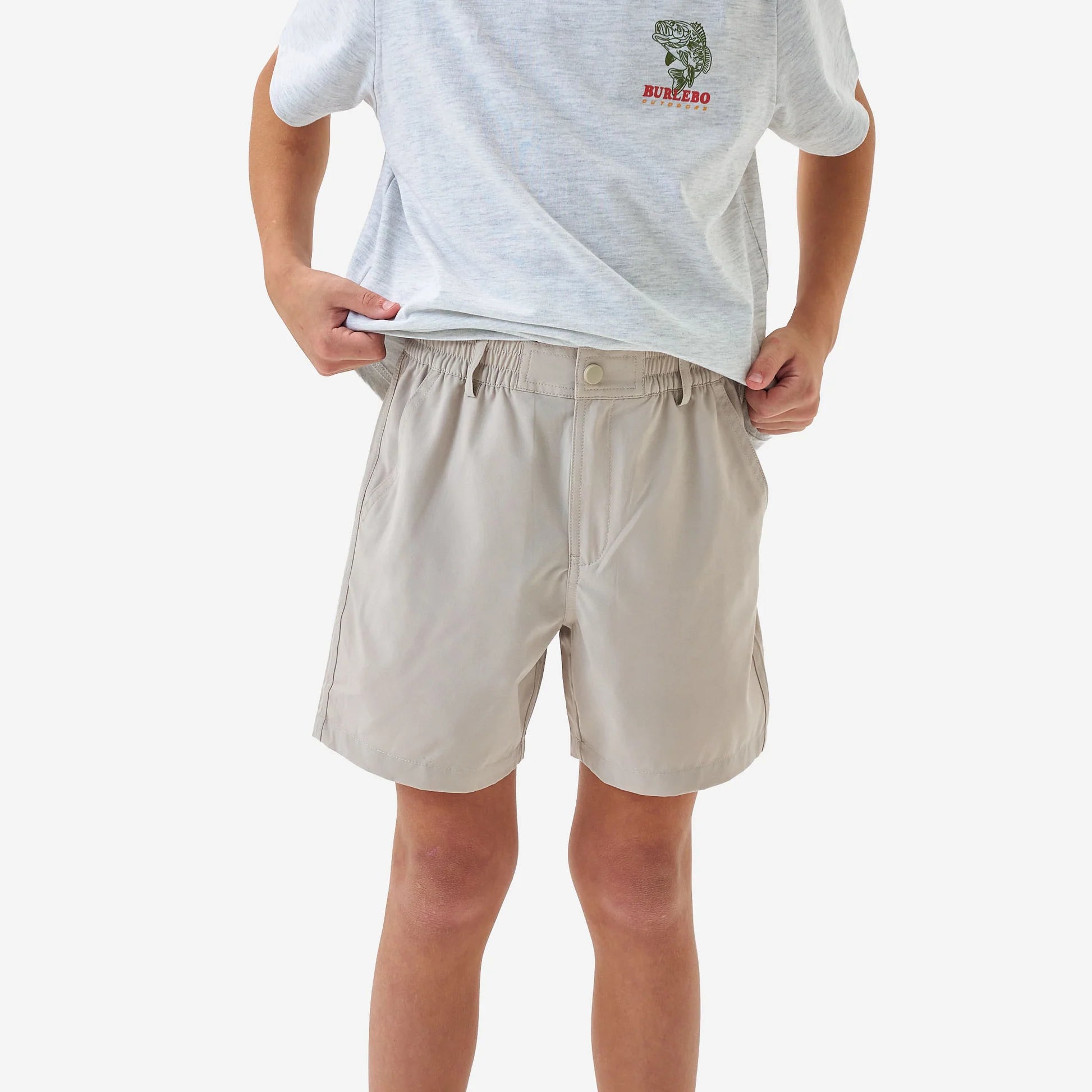 Person wearing beige shorts and a white t-shirt with a logo on a white background
