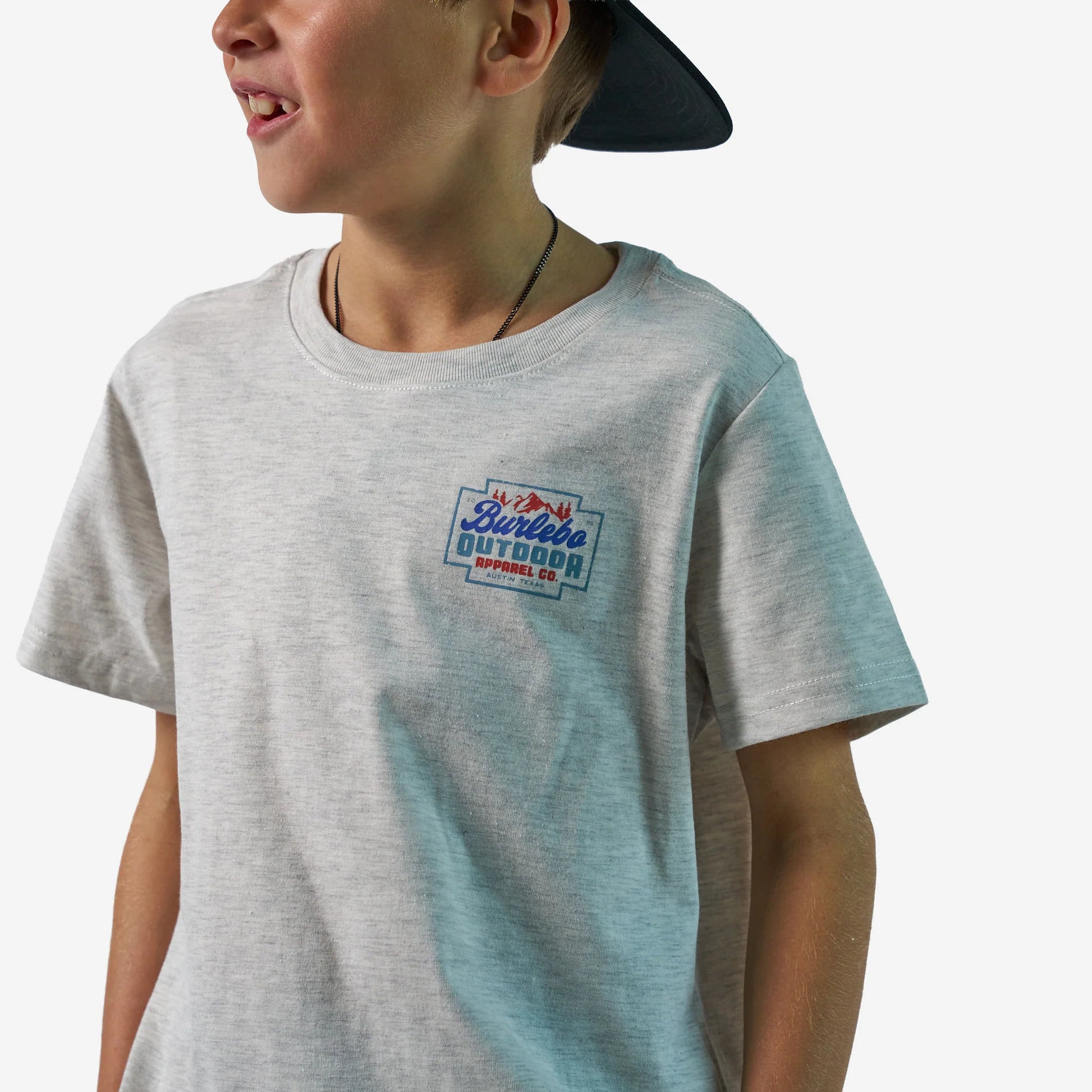 Child wearing a gray t-shirt with a logo on a white background