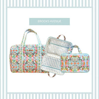 Set of travel bags with floral pattern on a light blue background, featuring the brand 'Brooks Avenue'.