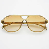 Gold-framed sunglasses with yellow-tinted lenses on a white background
