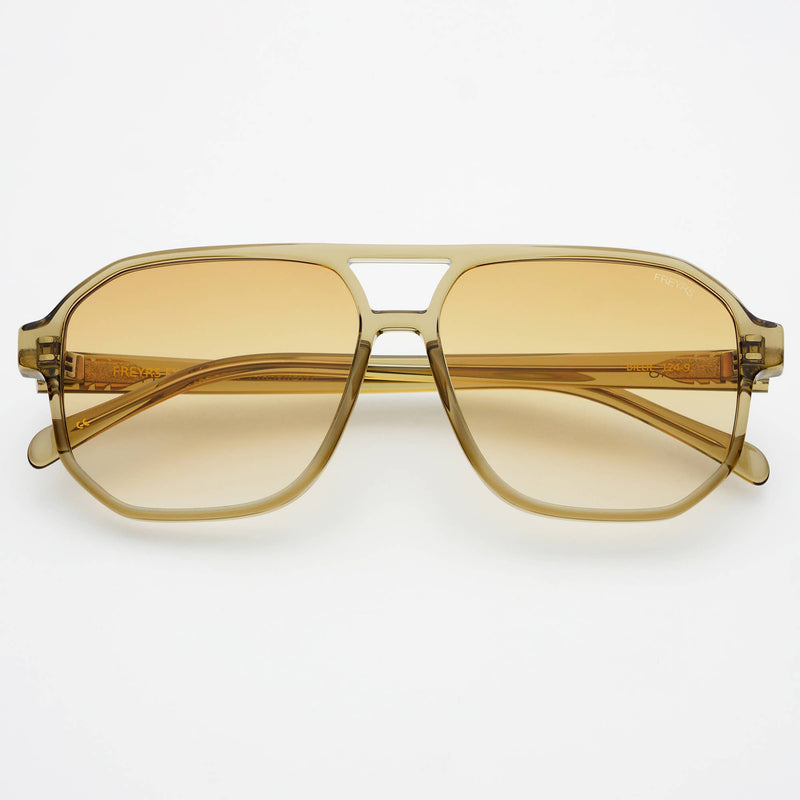 Gold-framed sunglasses with yellow-tinted lenses on a white background