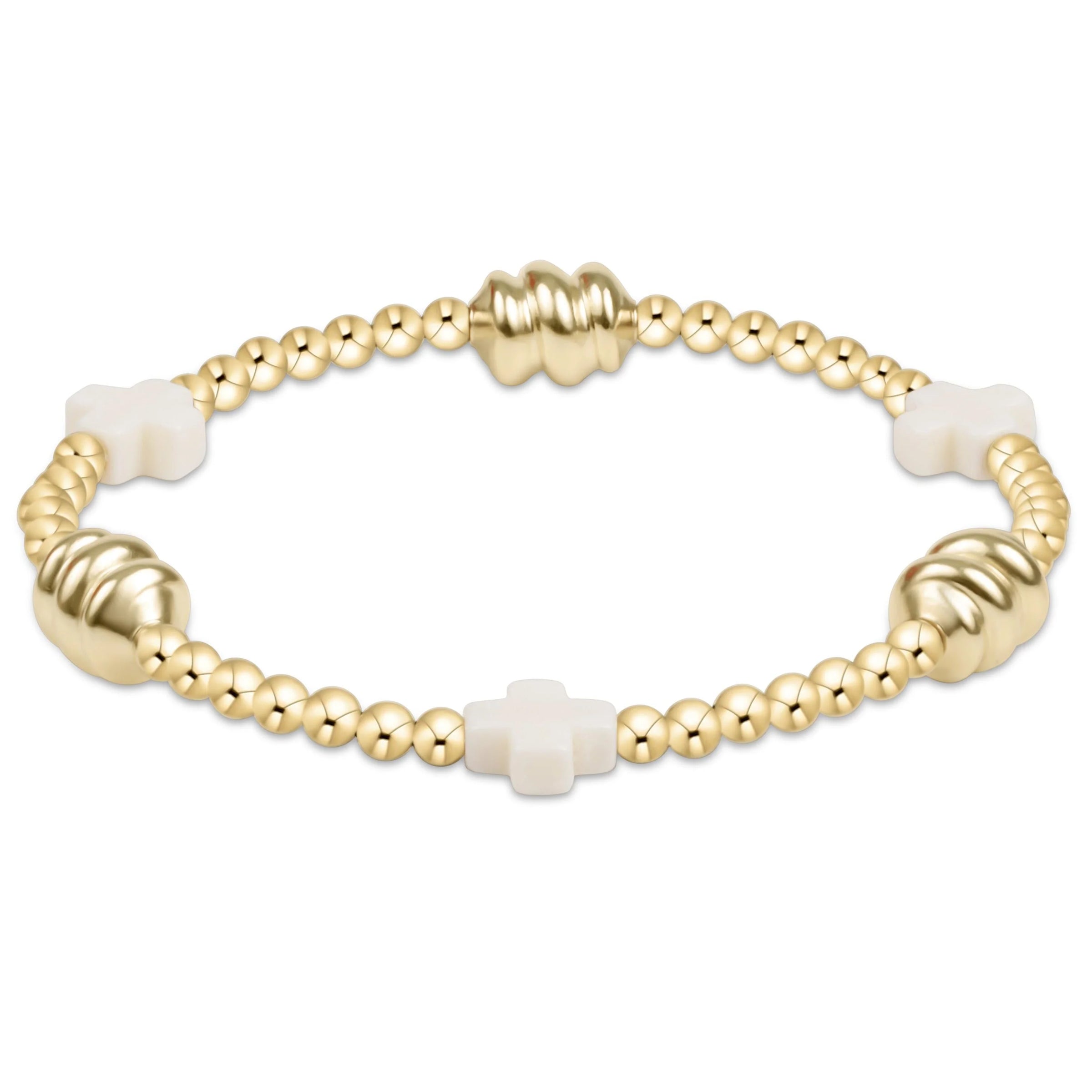 Gold bracelet with white beads on a white background

