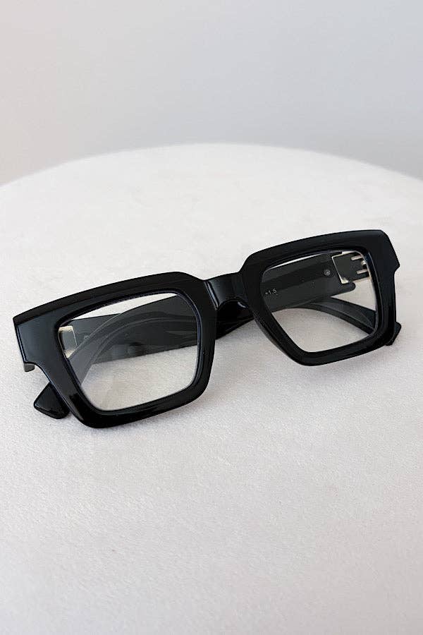 Black glasses on a white surface