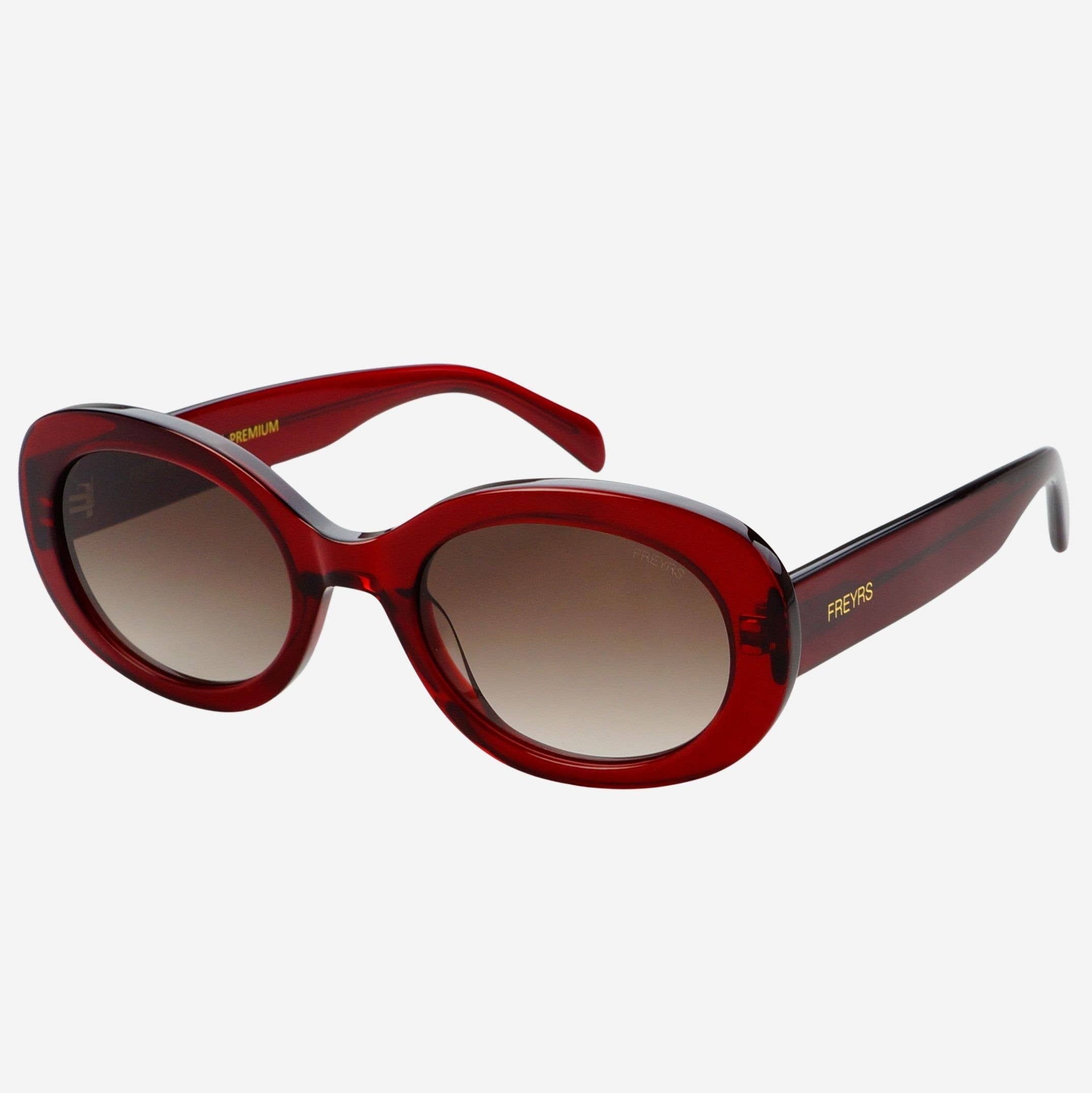 Red sunglasses with a gradient lens on a white background