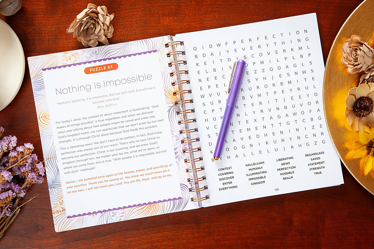 Open book with a puzzle and pen on a wooden surface with decorative elements