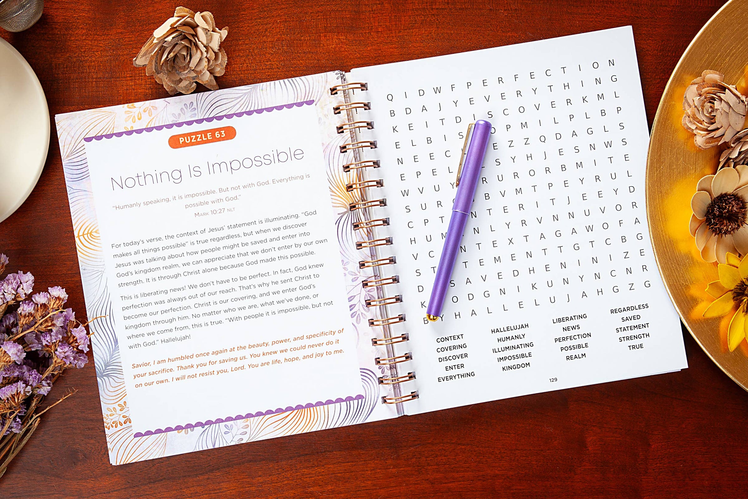 Open book with a puzzle and pen on a wooden surface with decorative elements