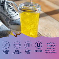Clear glass with yellow liquid on a wooden surface, with text about dietary labels and origin.