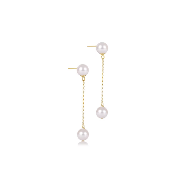 Pearl drop-style earrings on a gold chain on a white background. 