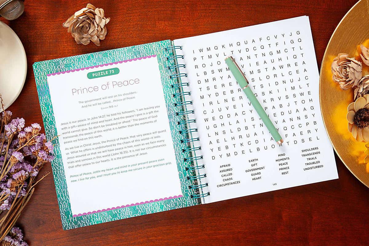 Open notebook with a word search puzzle on a wooden surface with decorative elements.