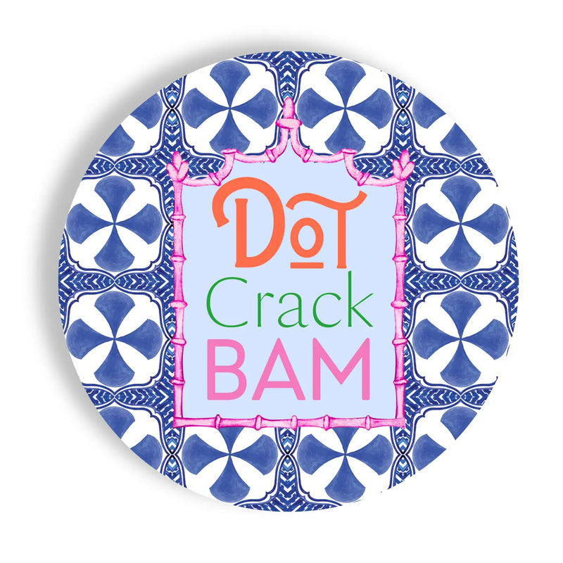 Decorative plate with blue and white pattern and colorful text 'Dot Crack BAM' on a white background