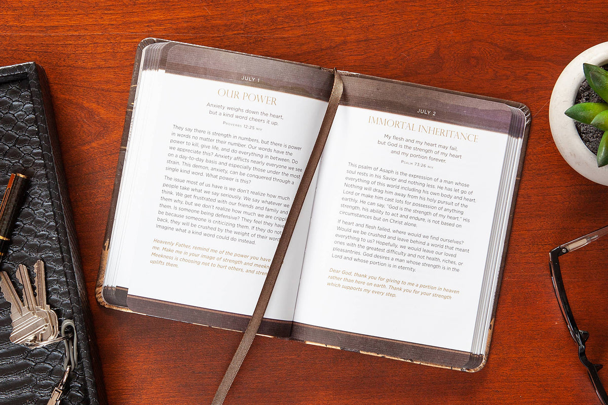 Open book on a wooden surface with a keychain and glasses nearby