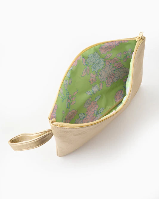 Cosmetic bag with floral pattern on green side and beige exterior on a white background