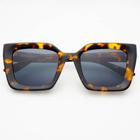 Sunglasses with tortoiseshell frame and dark lenses on a white background