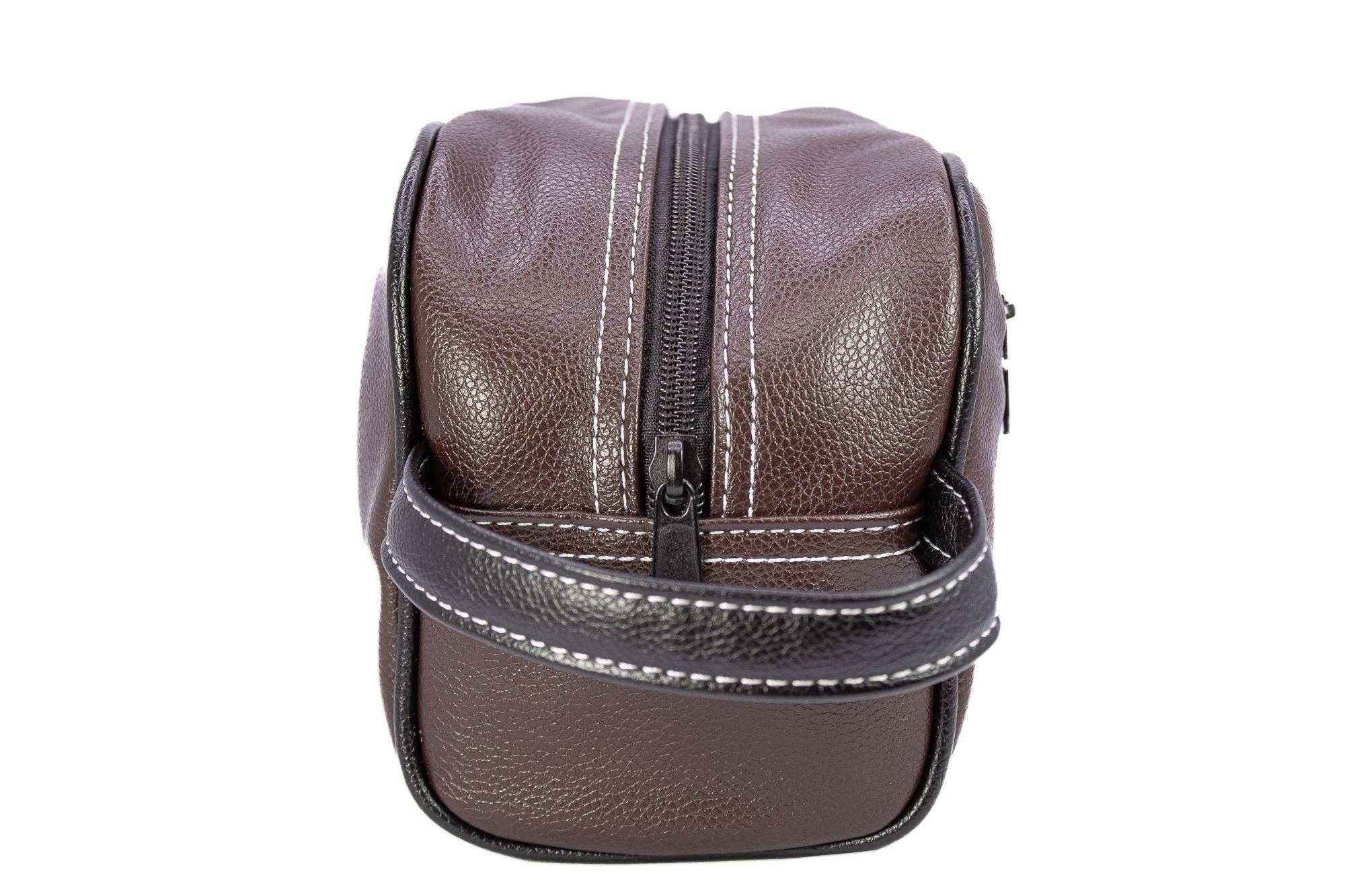 Brown leather travel bag with a zipper on a white background