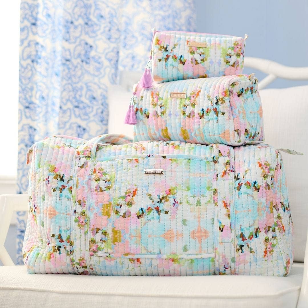 Floral quilt set on a white chair with a light blue background