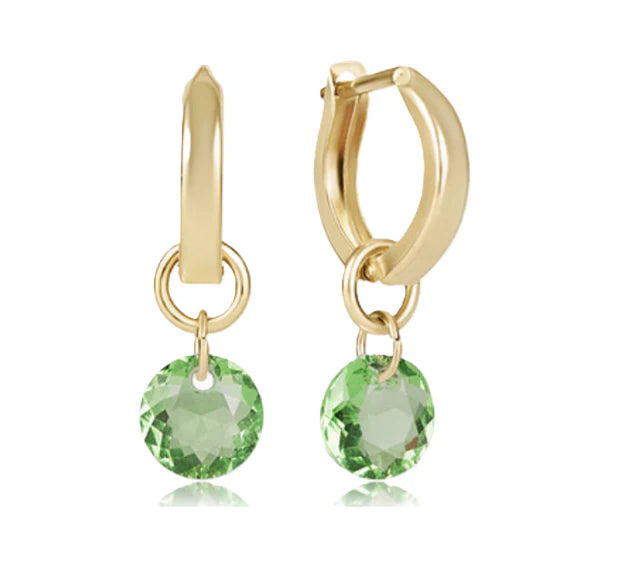 Gold hoop earrings with green gemstones on a white background