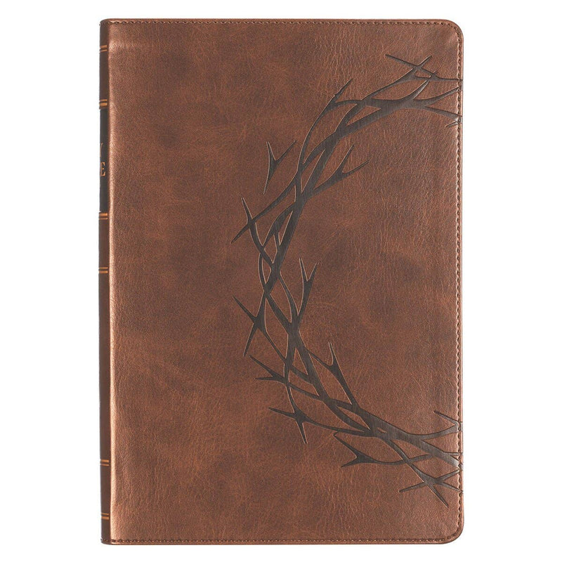 Brown leather notebook with embossed thorns on a white background