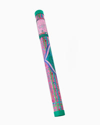 A rolled-up mahjong mat with a vibrant pink, green, and purple abstract pattern, shown in its protective plastic packaging tube against a plain white background.