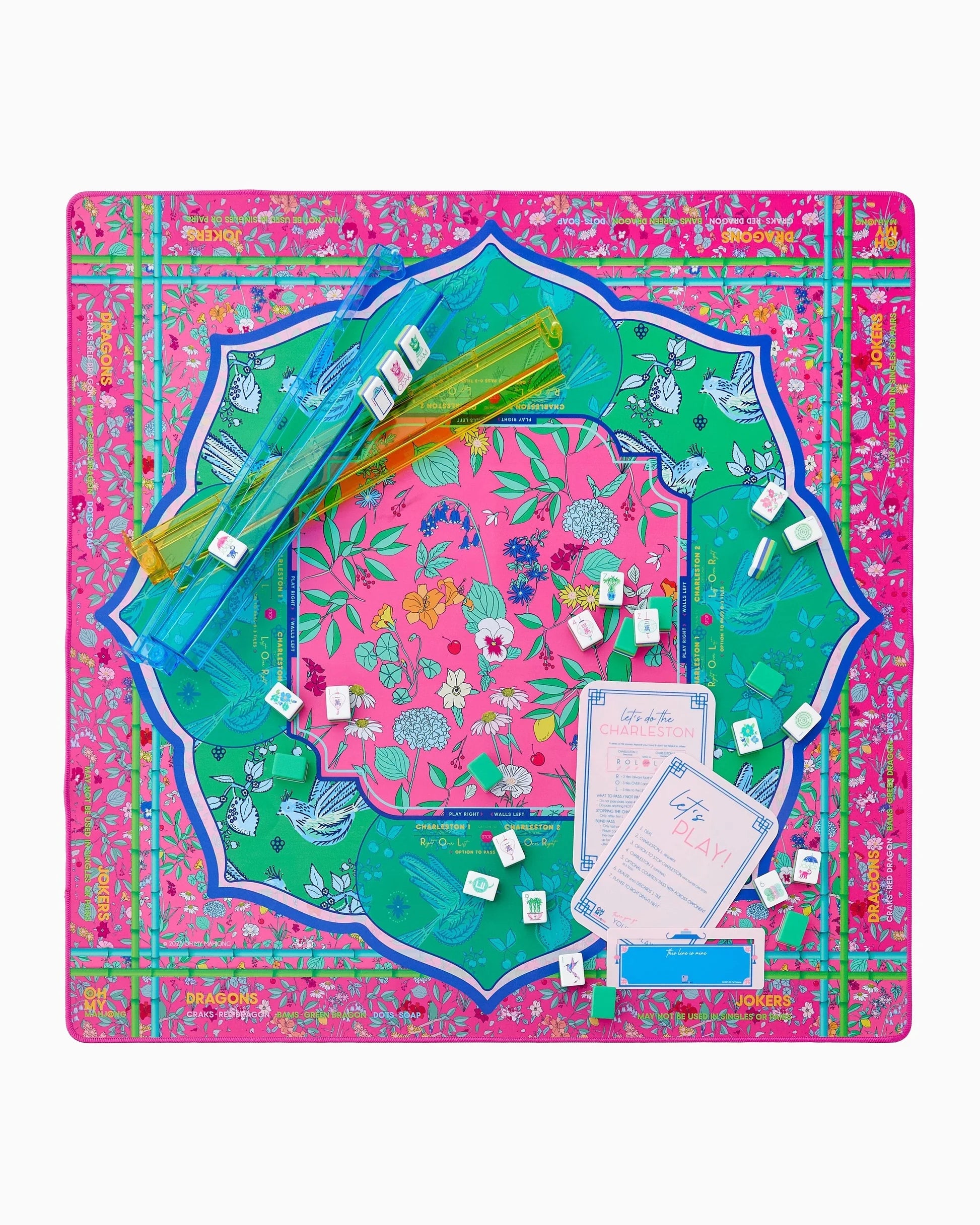 Colorful decorative mat with floral and bird patterns on a pink background