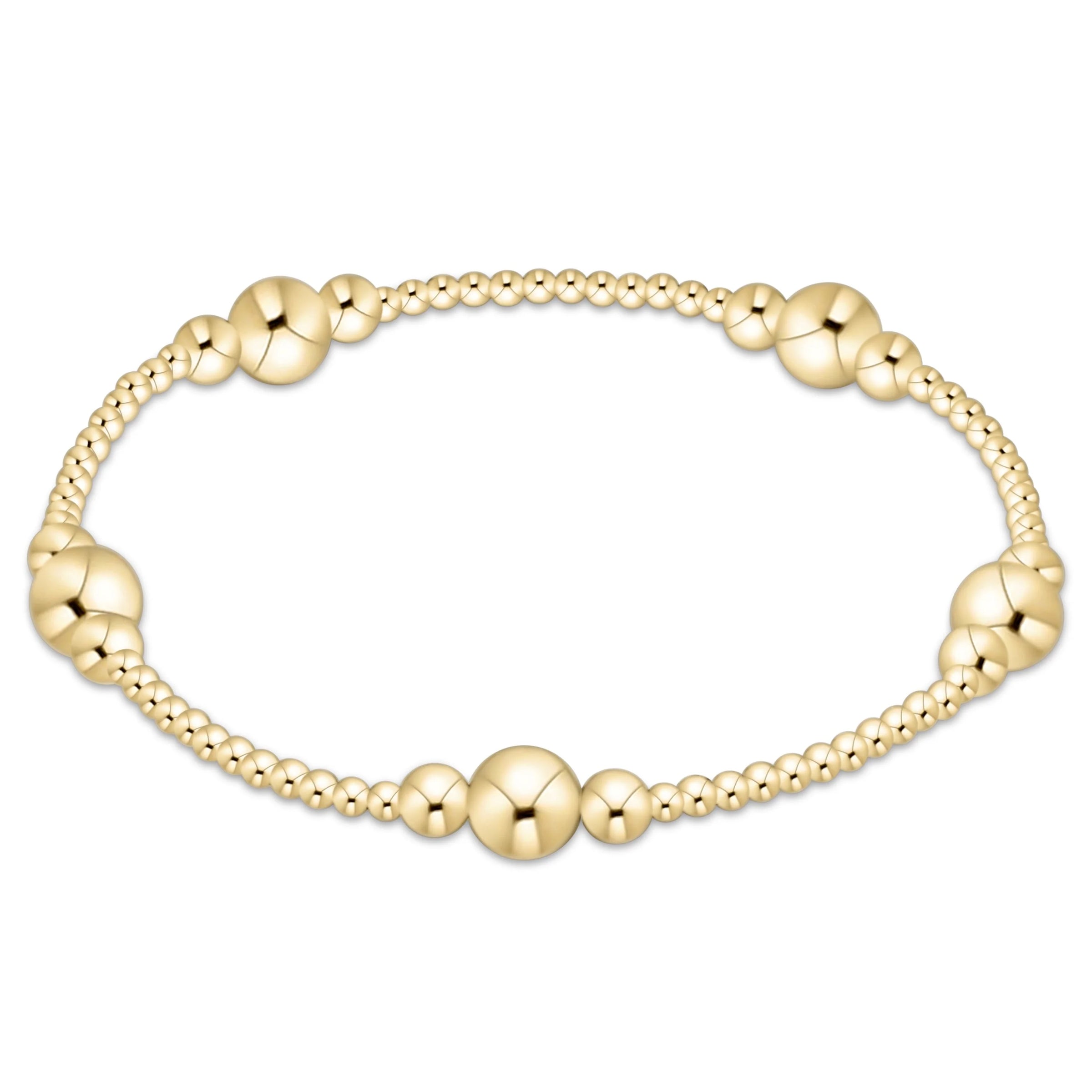 Gold beaded bracelet on a white background