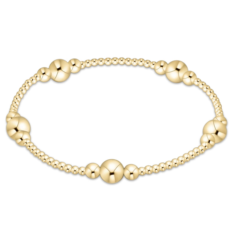 Gold beaded bracelet on a white background