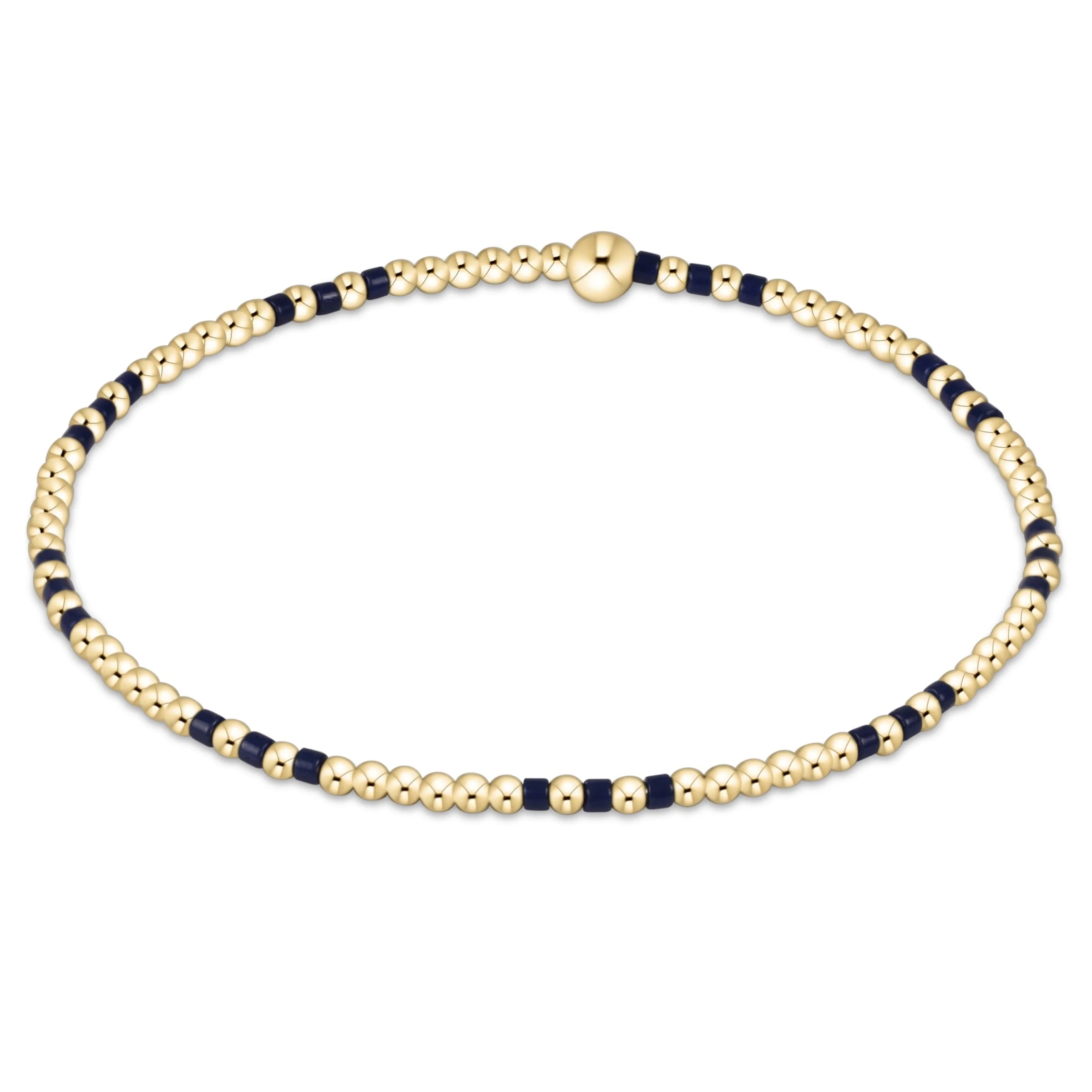 Gold and navy beaded bracelet on a white background