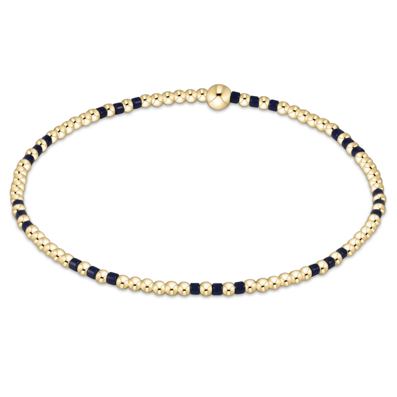 Gold and navy beaded bracelet on a white background
