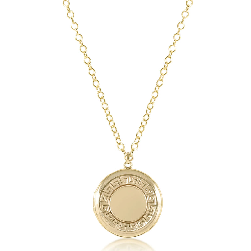 Gold necklace with a circular pendant on a white background
